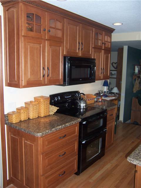 Hickory cabinets - Raised panel doors, drawer fronts, and side panels - Standard overlay style - Laminate countertops